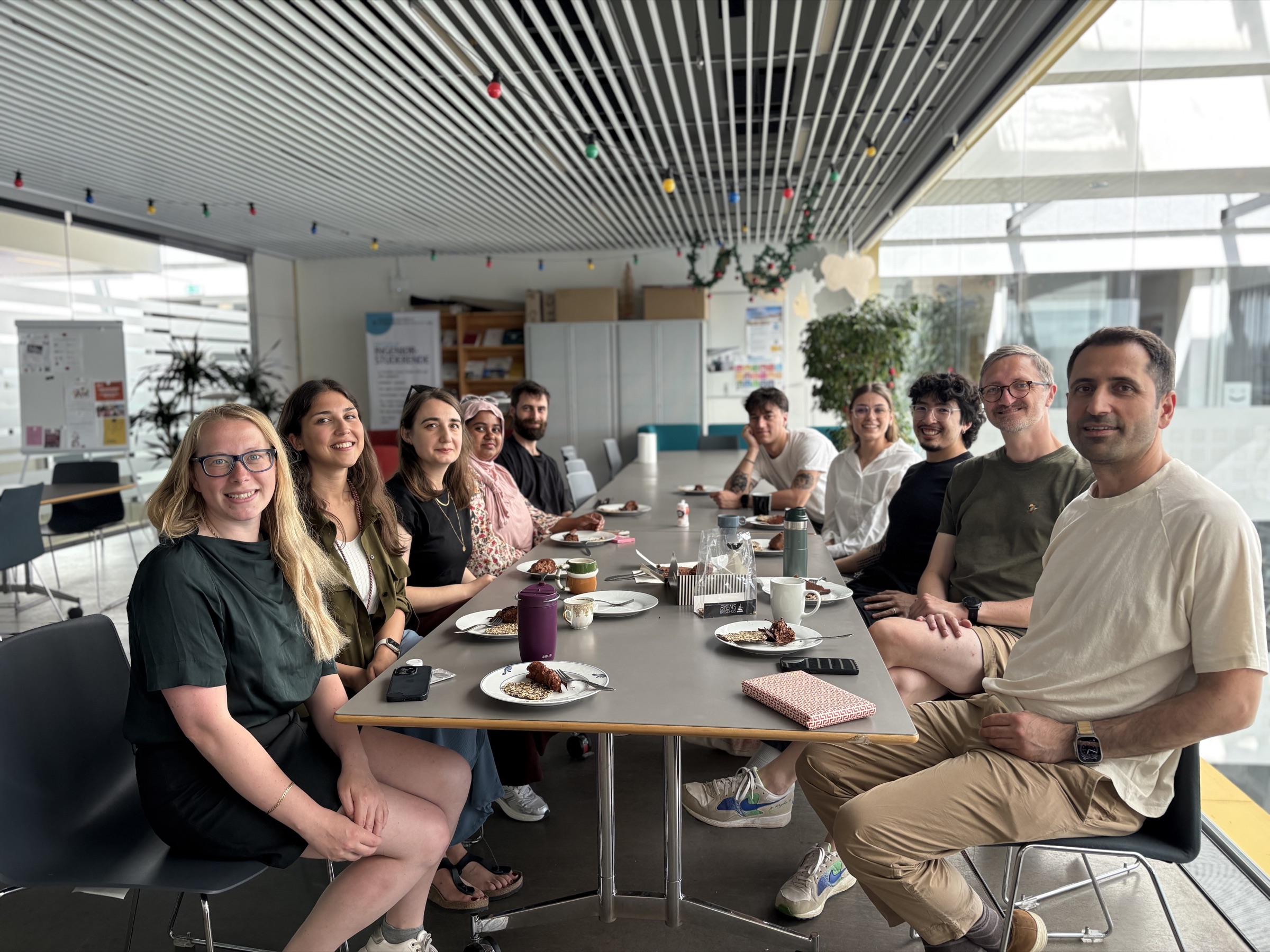 Members of the group seated around a table at the Centre for Industrial Software.